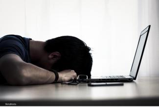 man with head on desk
