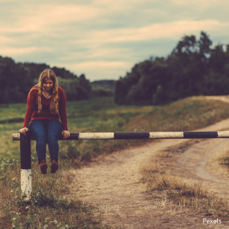 girl sitting on railing