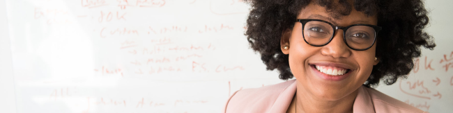 African American woman next to white board